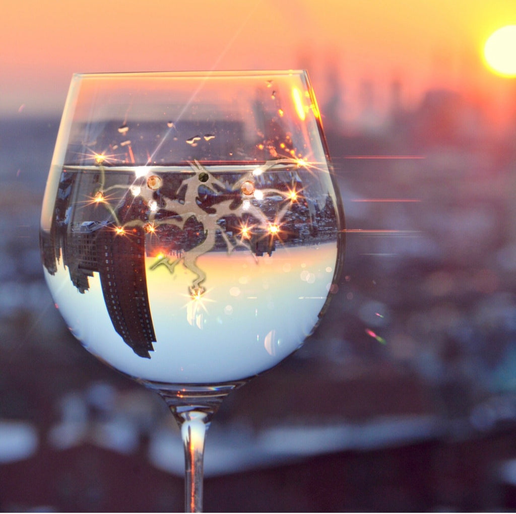 Dragon 2 hand-etched wine glass with Swarovski crystals at sunset