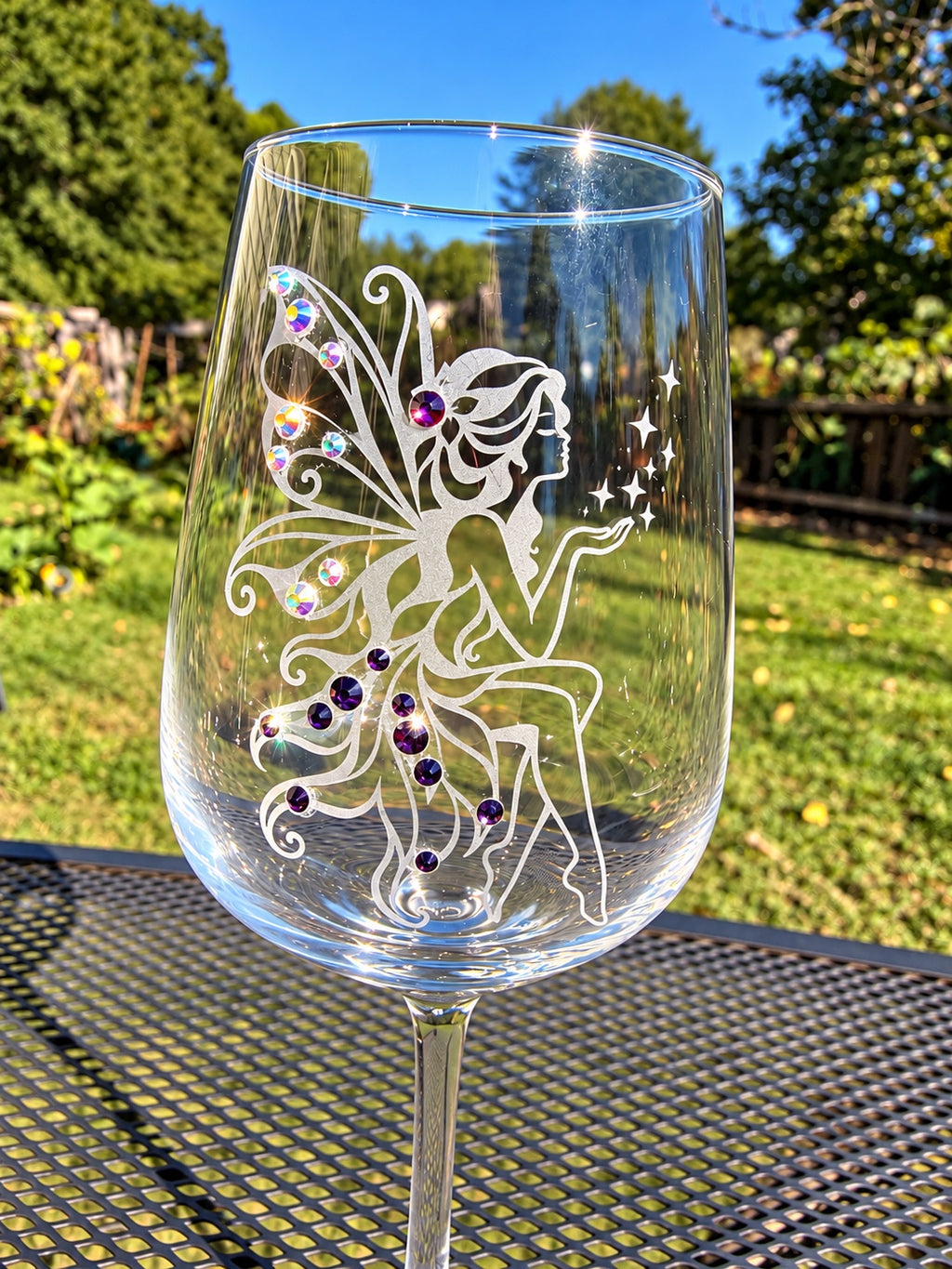The Fairy hand-etched wine glass with sparkling purple crystals outdoors